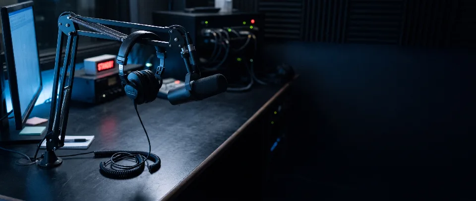 A headset on a microphone stand in the studio at night